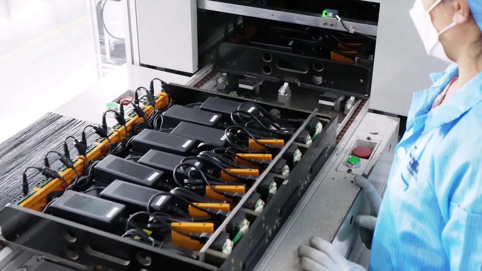Finished AC/DC power adapters on an automated test rack