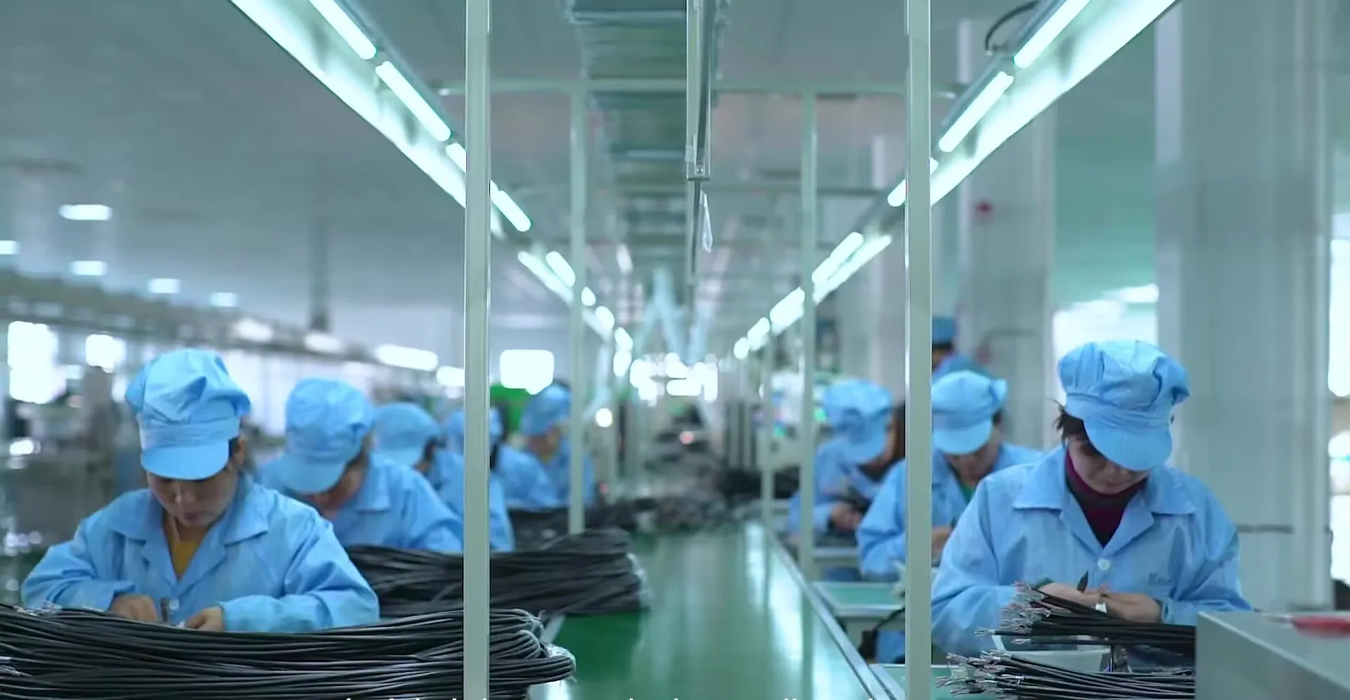 Assembly line of technicians building power and cable hardware on a Kestner production line